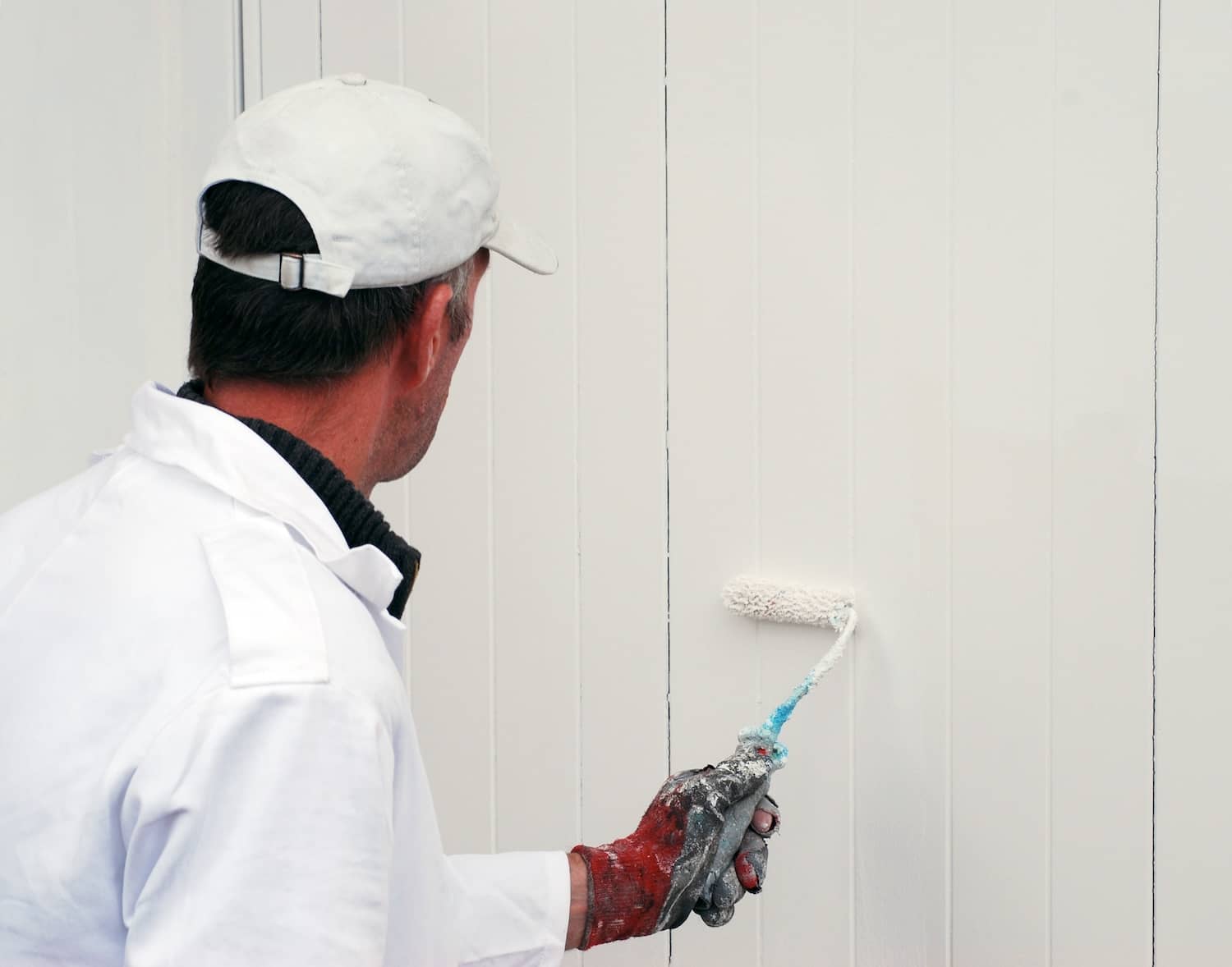 Person painting a garage door