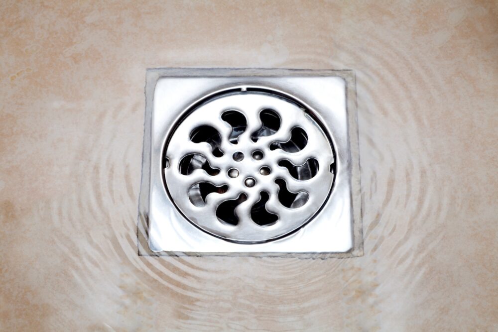 water flowing over into metal floor drains