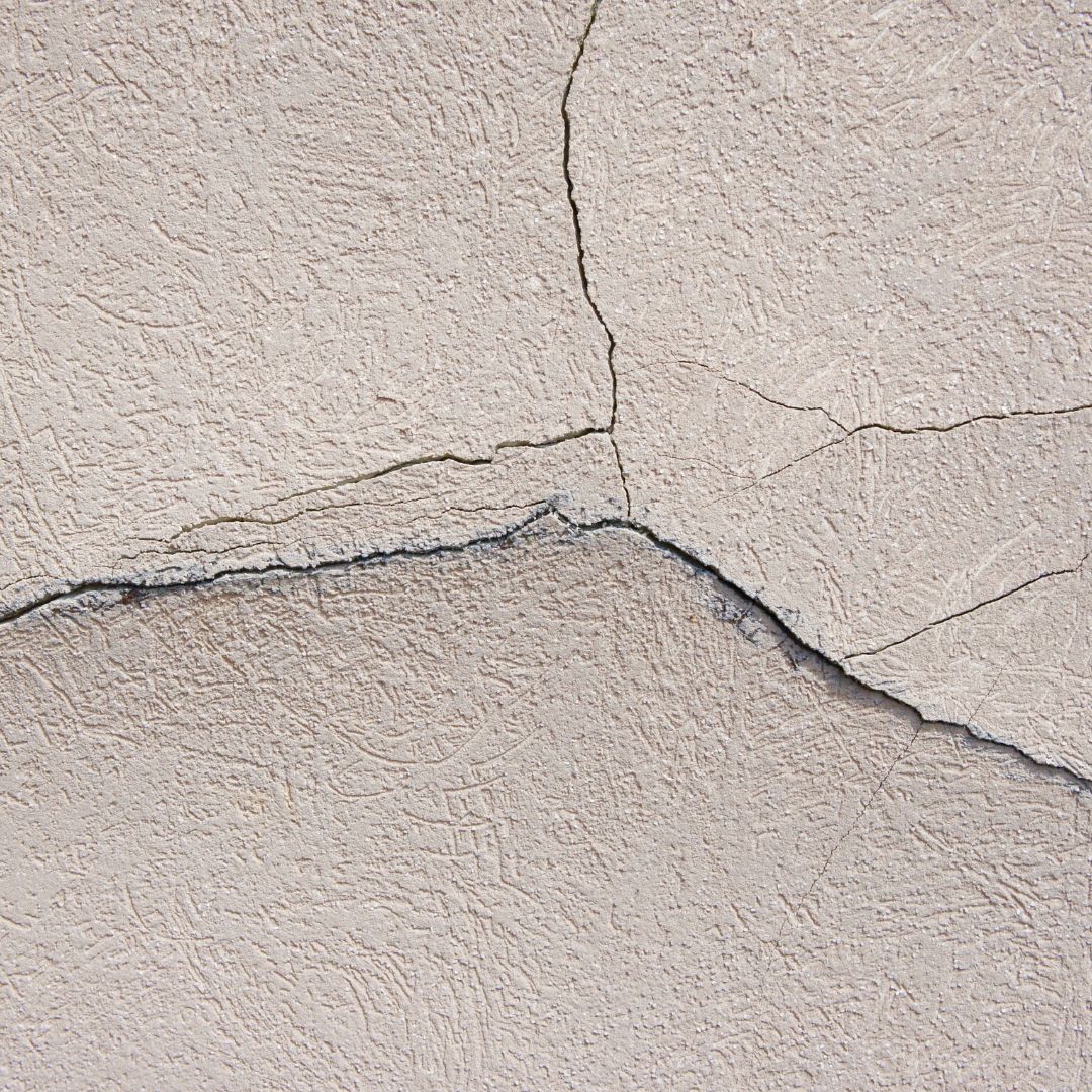 worn stucco on house exterior