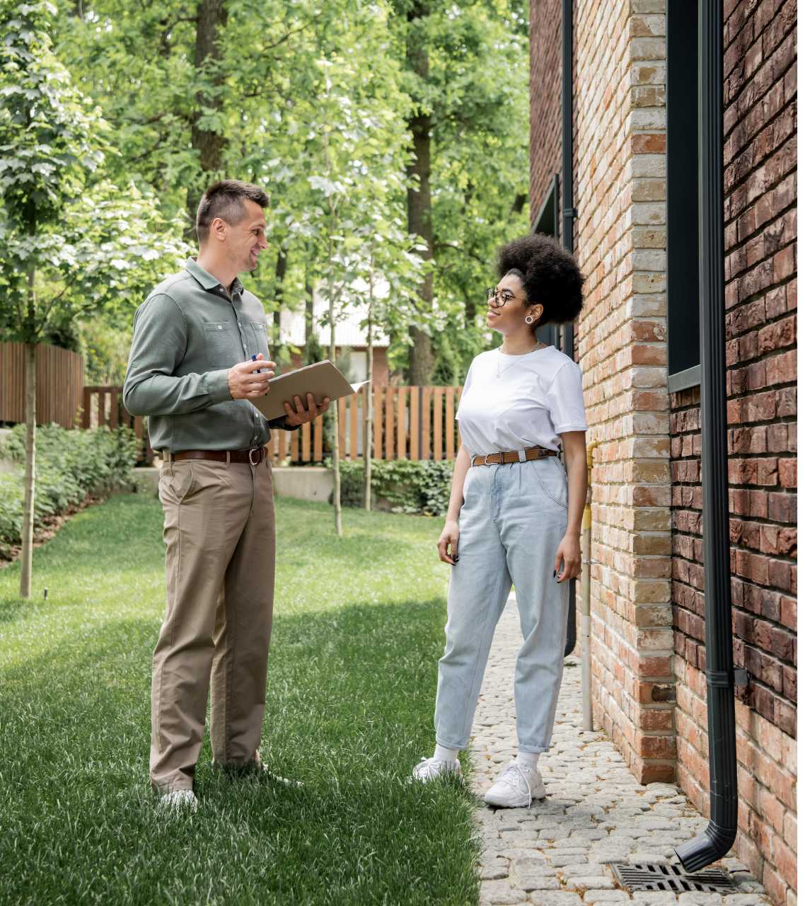 Woman outside property talking to inspector after inspection